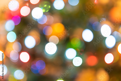 Background of blurred colorful, multicolored, multi-colored, Christmas ornament bokeh round circles of green, red, orange, blue colors