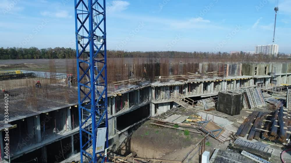 Building construction, construction site and workers.