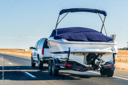 Truck towing a  boat on the interstate, California