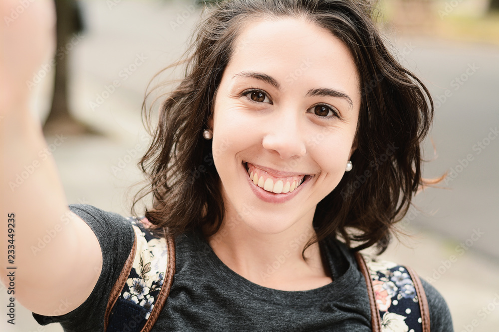 Portrait of young woman taking selfie. Portrait of young woman taking selfie.
