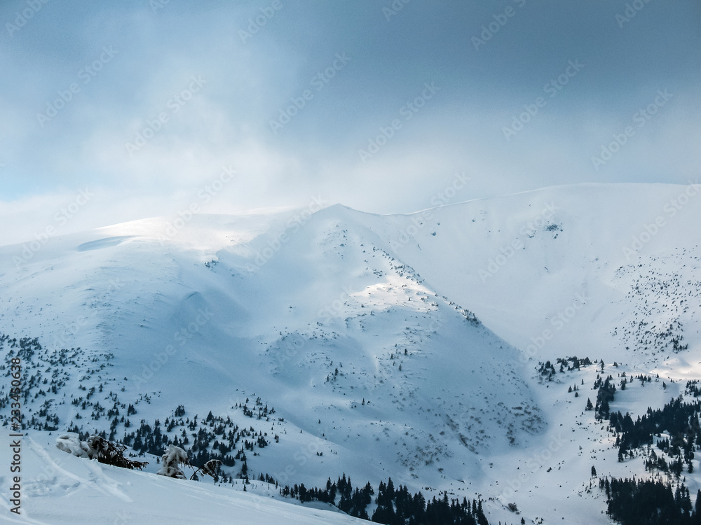 Beautiful snowy mountain ridge in the Carpathians in Ukraine. Mountain winter landscape.