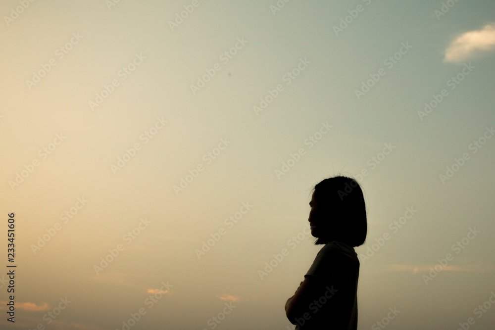 Asian woman silhouette over sunset