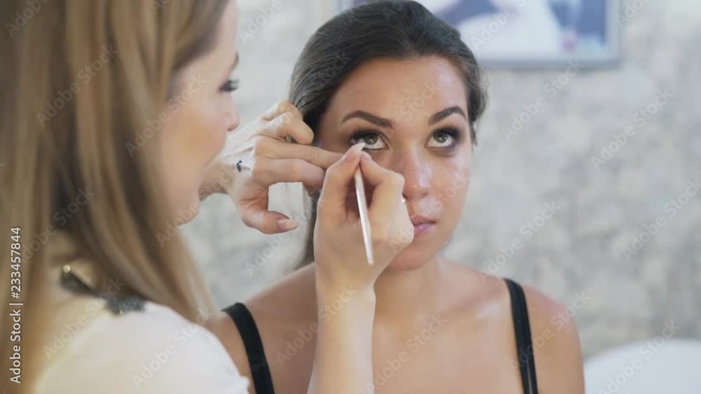 Make-up artist's work concept, makeup. Close-up make-up carefully paints the eyeliner