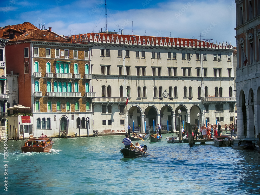 Venice cityscape with tourists on gondolas