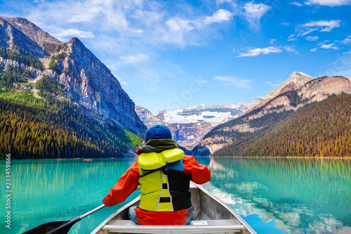 Boy Canoeing on Lake Louise in Banff National Park Canada