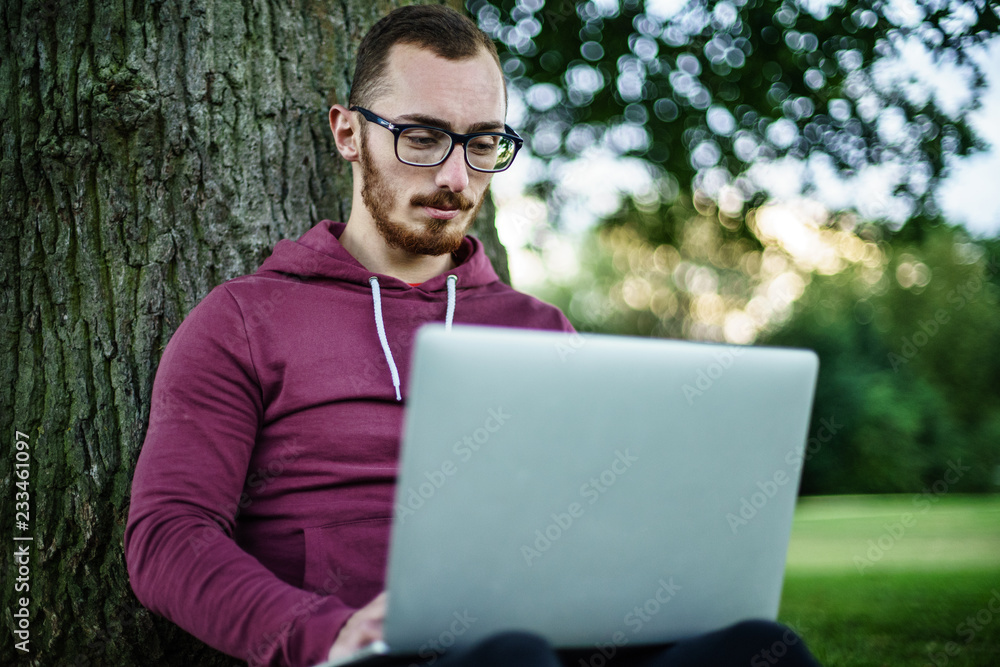 Software developer coding in park Software developer coding in park