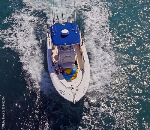 Overhead view of a sport fishing boat with blue canvas canopy © Wimbledon