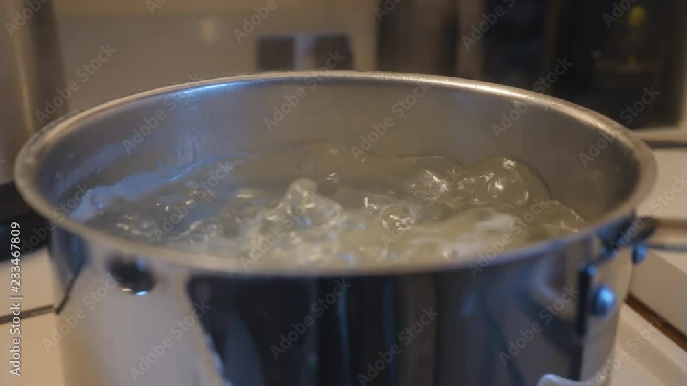 Taking a lid off a pot of boiling water with potatoes on stove top. Taking a lid off a pot of boiling water with potatoes on stove top.