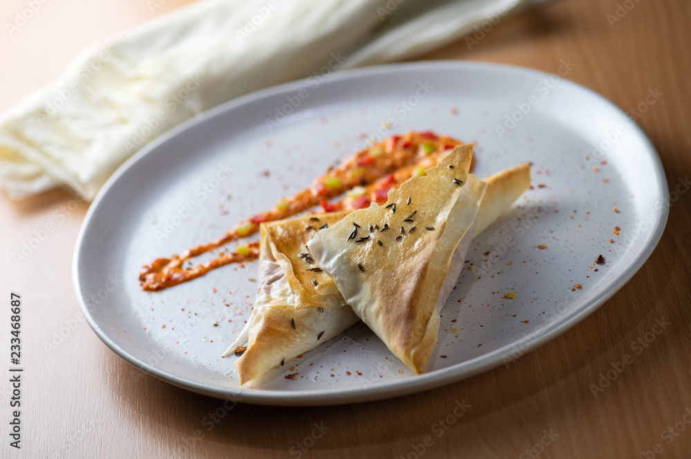Baked triangles with traditional sauce (ajvar) and cheese
