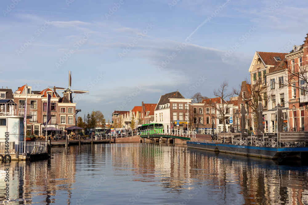 Medieval picturesque city of Leiden in the Netherlands with old historic cityscape on a sunny afternoon with a Windmill in the background