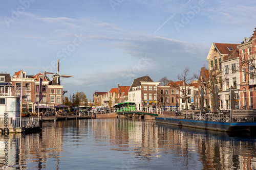 Medieval picturesque city of Leiden in the Netherlands with old historic cityscape on a sunny afternoon with a Windmill in the background