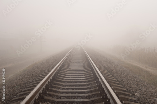 Foggy railway landscape. Horizontal photo.