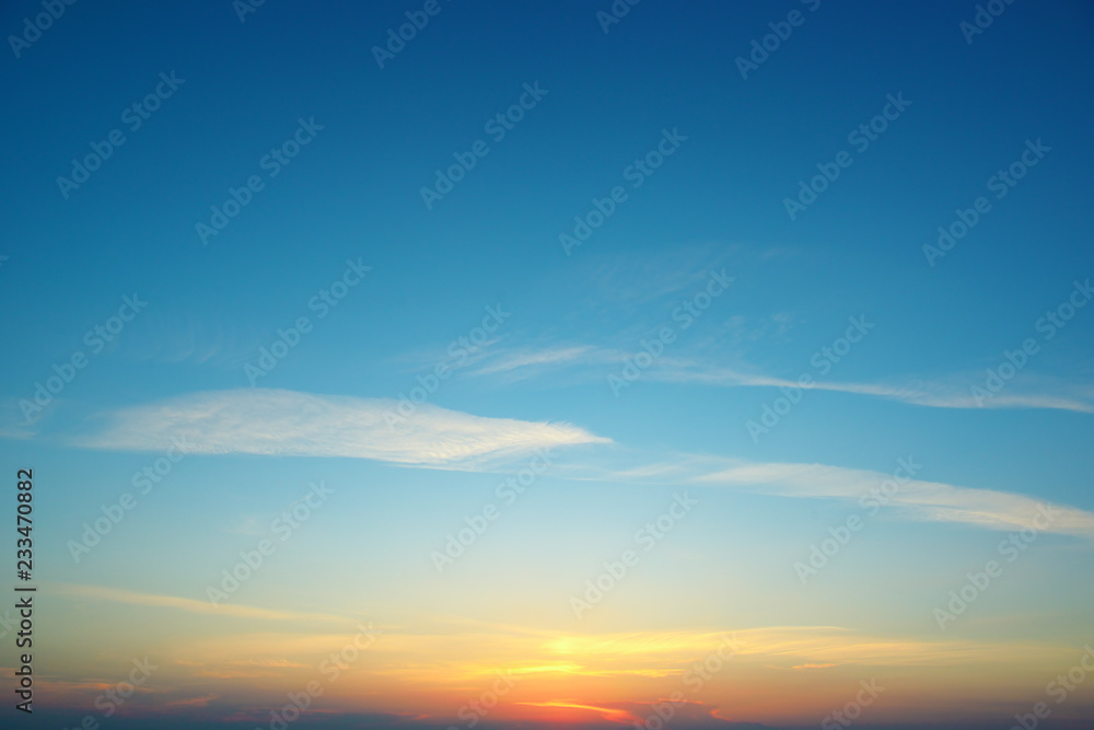 Obraz premium Sunset against blue sky and clouds
