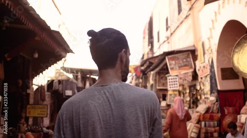 a younger man exploring the moroccan souk in jemaa el fna