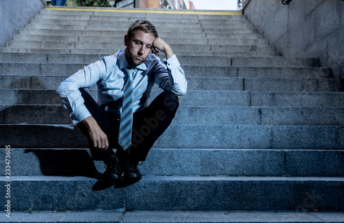 Depressed sad business man in total despair felling hopeless and frustrated sitting in city stairs © SB Arts Media