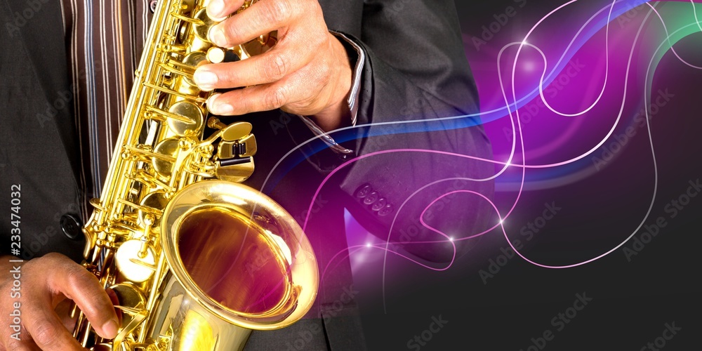 Obraz premium Close-up man playing on saxophone on blurred background