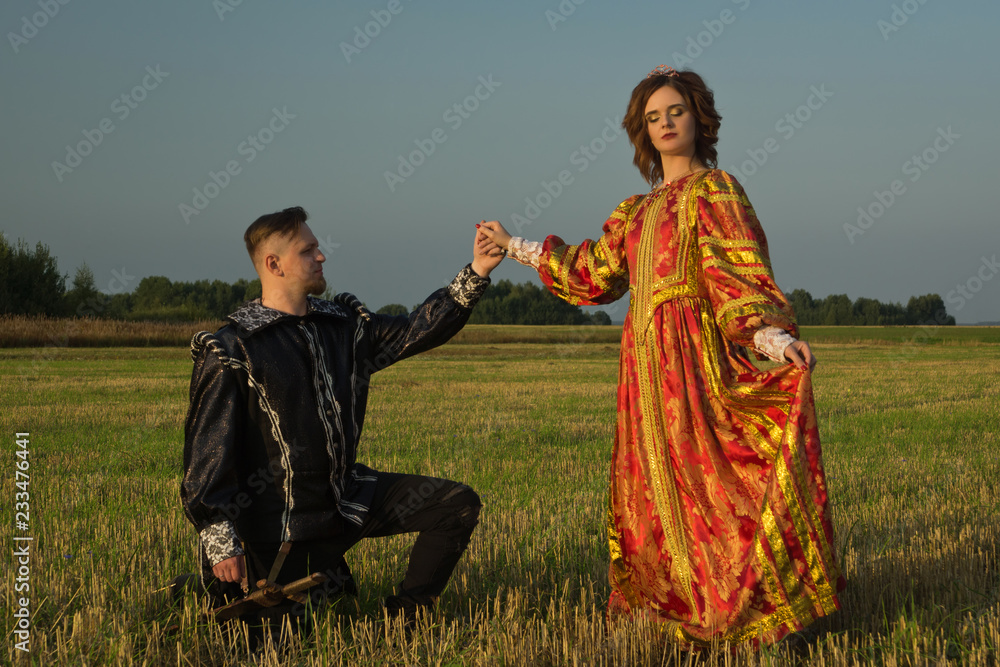 Knight with sword and girl in renaissance dress