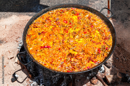 Seafood Paella. The national Spanish dish of paella in a large skillet is cooked on an open fire, at the stake.