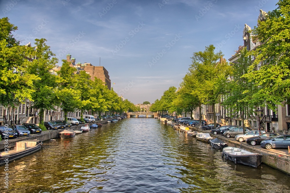 Boats on Amstel river in Amsterdam, Holland, Netherlands, HDR