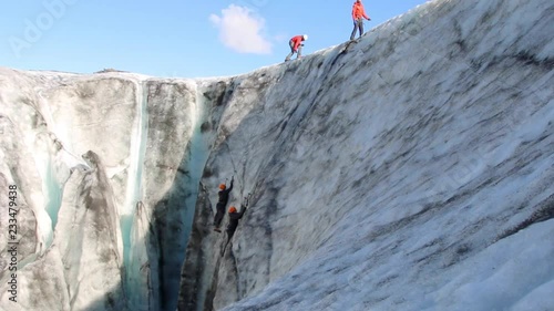 Iice climbing a moulin in Solheimajokull glacier on the South Side of Iceland. photo