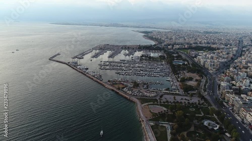 Aerial view. Sailing boats and motor yachts moored at the quays and protected from the waves in a safe Marina. View from a great height on the largest in Athens yacht Marina Alimos. photo