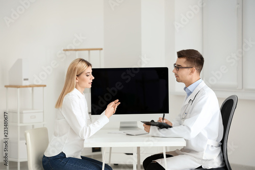 Male doctor consulting pati...