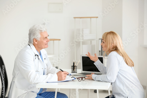Male doctor consulting pati...