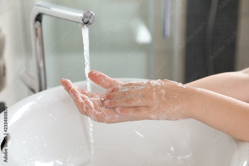 Little boy washing hands with soap over sink in bathroom, closeup Little boy washing hands with soap over sink in bathroom, closeup