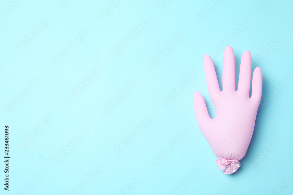 Inflated medical glove on color background, top view. Space for text Inflated medical glove on color background, top view. Space for text
