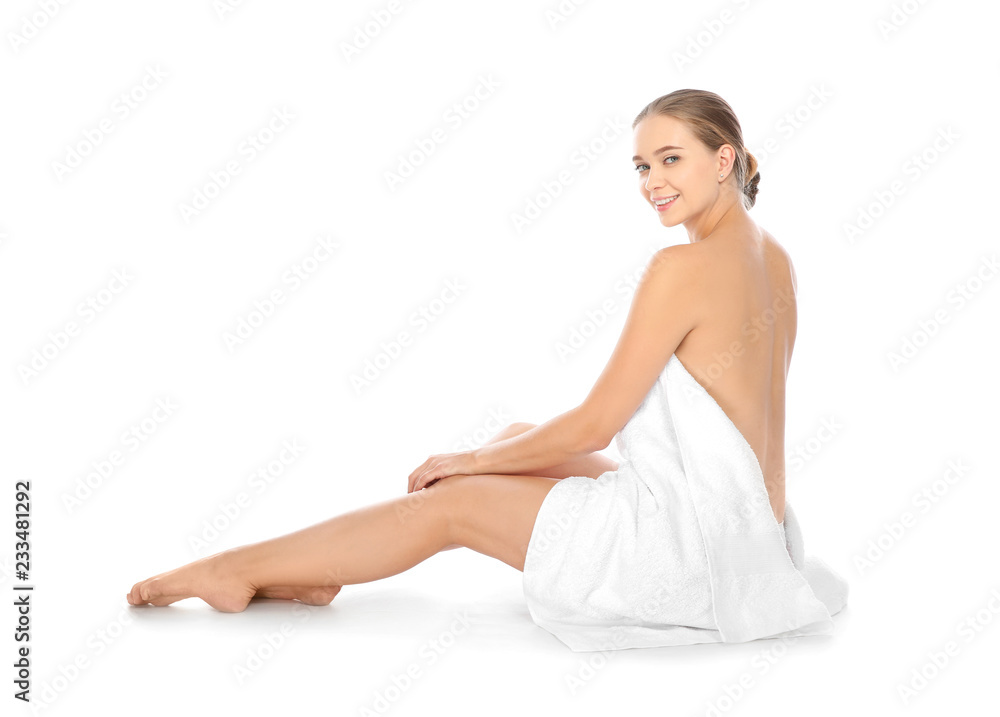 Portrait of young pretty woman with towel sitting on white background Portrait of young pretty woman with towel sitting on white background