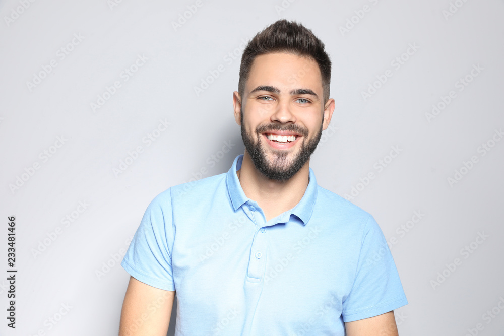 Portrait of handsome young man against light background Portrait of handsome young man against light background