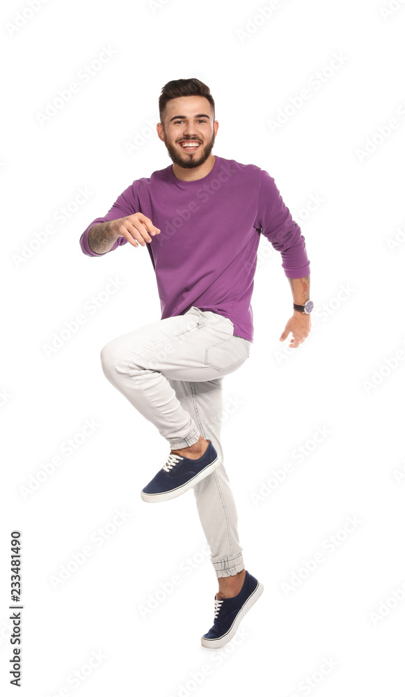Handsome young man jumping on white background Handsome young man jumping on white background