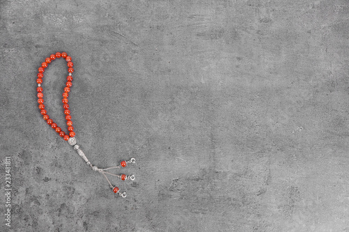 Muslim prayer beads and space for text on grey background, top view