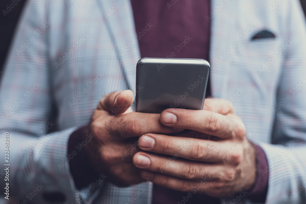 Close up of the male hands holding carefully modern convenient smartphone Close up of the male hands holding carefully modern convenient smartphone
