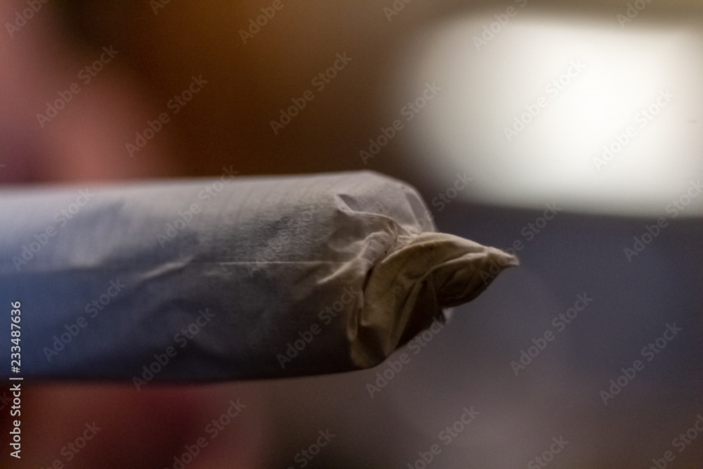 Macro close up of the tip of a joint or marijuana cigarette before it is lit.