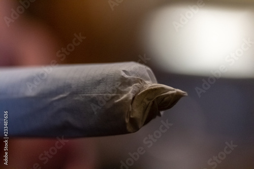 Obraz na płótnie Macro close up of the tip of a joint or marijuana cigarette before it is lit. w salonie