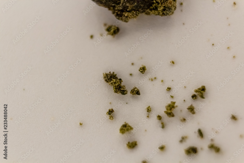 Ball of marijuana sift crumbling on a white background.