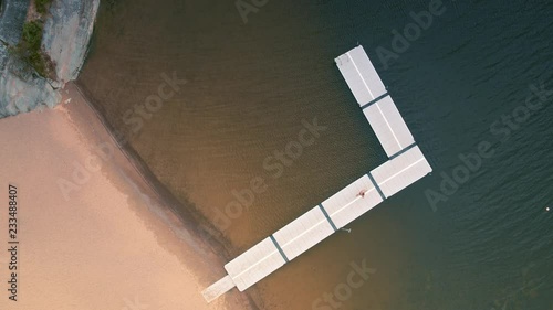 Beautiful top shot of a young woman diving into a lake photo