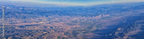 Aerial view of topographical Rocky Mountain landscapes on flight over Colorado and Utah during autumn. Grand sweeping views of rivers, mountain and landscape patterns. Top view, Rockies and Wasatch Fr