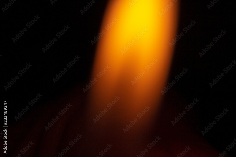 An orange isolated flame on a black background