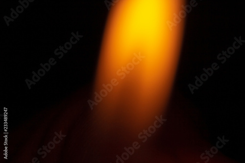 Obraz na płótnie An orange isolated flame on a black background w salonie
