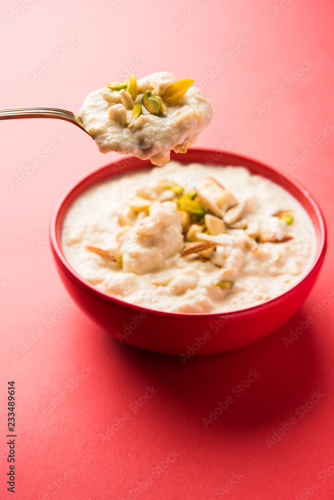 Sweet Rabdi or Lachha Rabri or basundi, made with pure milk garnished with dry fruits. Served in a bowl over moody background. Selective focus Sweet Rabdi or Lachha Rabri or basundi, made with pure milk garnished with dry fruits. Served in a bowl over moody background. Selective focus