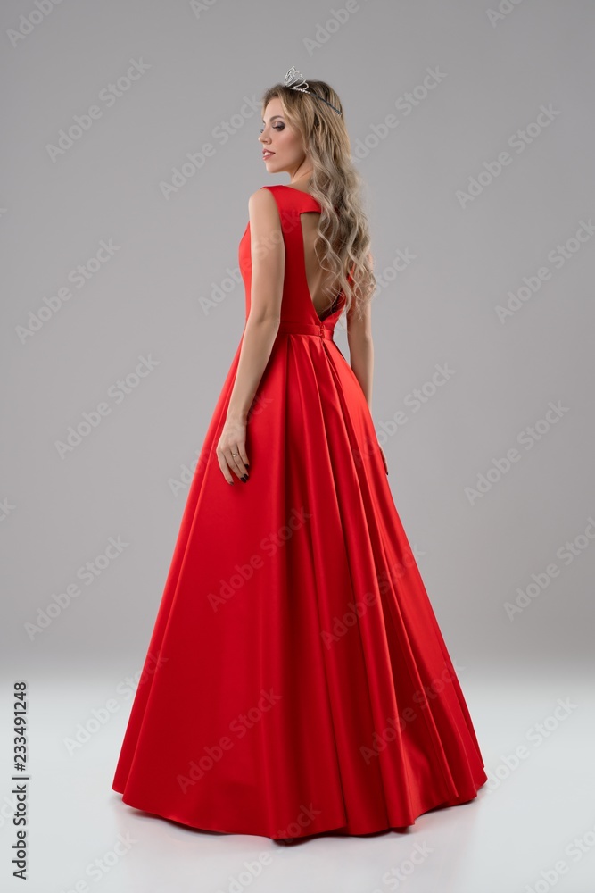 Pretty blonde in luxurious red evening dress shot
