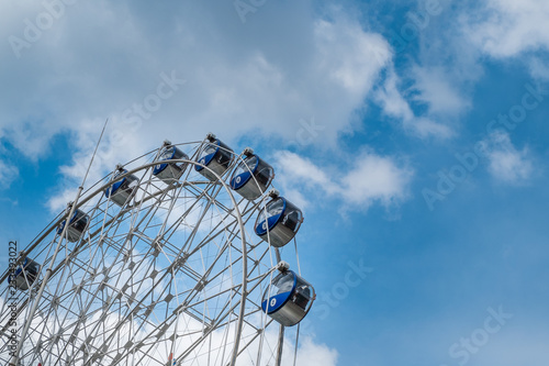 Wheel with the sky and the clouds are beautiful.