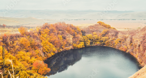 Mountain lake landscape. Reflection with autumn trees.The lake is karst origin, Shadhurey, North Caucasus, Kabardino Balkariya.  © taylon