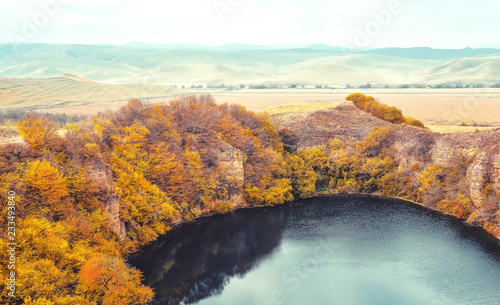Mountain lake landscape. Reflection with autumn trees.The lake is karst origin, Shadhurey, North Caucasus, Kabardino Balkariya.  © taylon