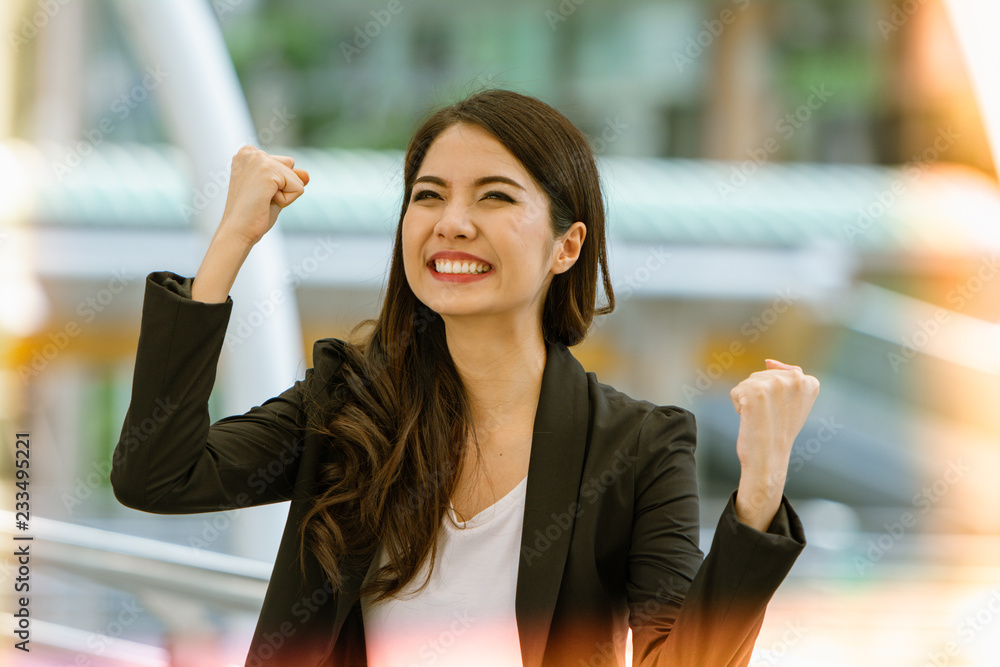 Excited successful business woman smiling and raised hands up celebrate with happily , successful winner businesswoman with fists up, keep fighting, You can do it concept.