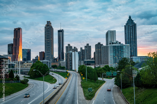 Calm roads flowing against city skyline right after sunset, summer evening. Atlanta, USA.