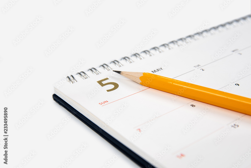 May calendar and pencil on white background. May calendar and pencil on white background.