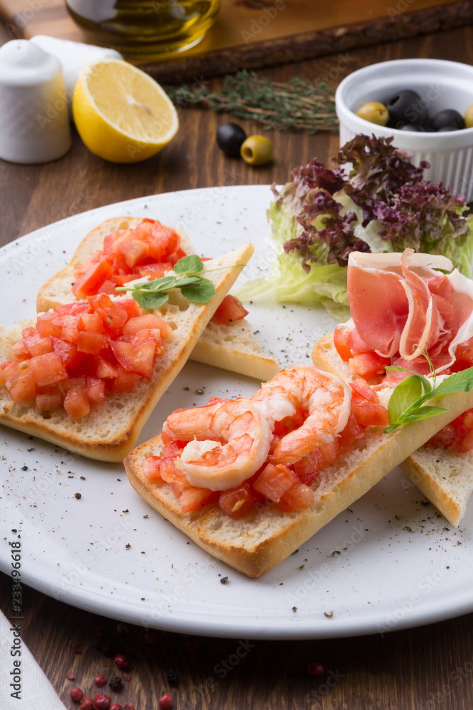 Italian sandwiches with tomatoes, shrimps and prsciutto bacon